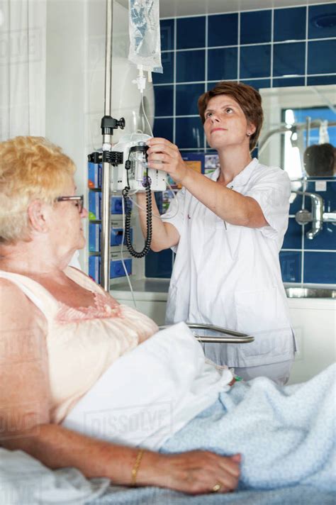 Nurse Adjusting Patients Intravenous Drip Stock Photo Dissolve