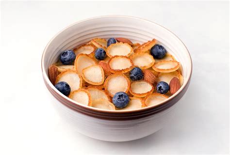 Healthy Breakfast Of Tiny Pancake Cereal With Berries And Nuts On A