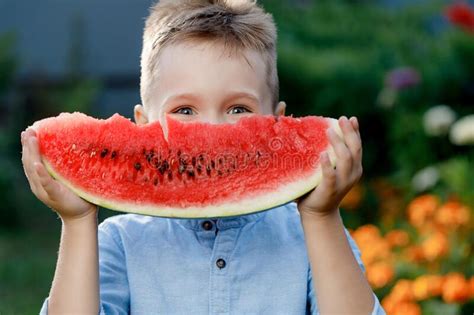 Funny Baby Boy Eating Watermelon Outdoors On A Summer Day Baby