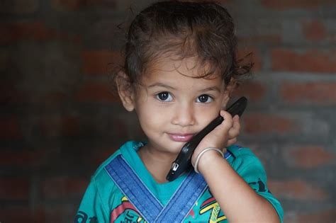 Premium Photo Beautiful Indian Baby Girl Kid Face Using Mobile