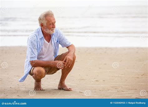 Senior Man Sitting On Beach Relaxing Happy Retired Man Relaxed On