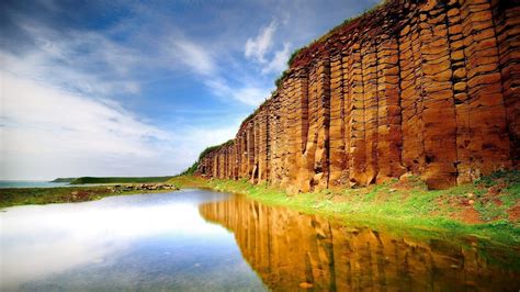 Brown Cliff Near Body Of Water Photo Nature Landscape Rock Formation