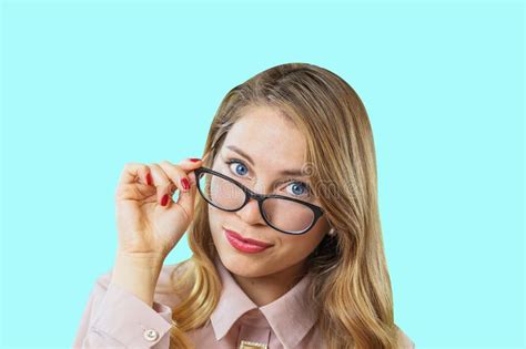 Portrait Of An Attractive Young Blonde With Glasses Looking Into The