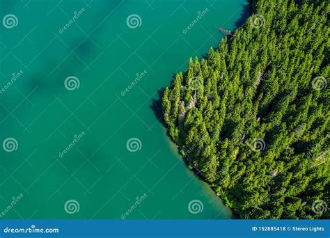 Mountain Lake With Turquoise Water And Green Trees Reflection In The