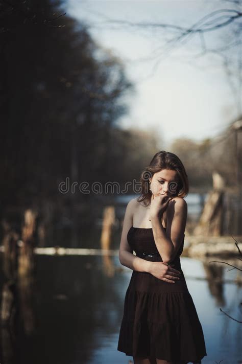 Brunette Girl Stands By The Tree Near The Water Stock Image Image Of