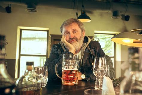 The Sad Senior Bearded Male Drinking Beer In Pub Stock Image Image Of