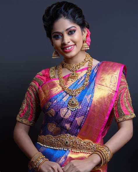 In A Bridal Look In Dark Blue And Pink Color Pattu Kanjeevaram Saree Elbow Length Sleeve Blouse