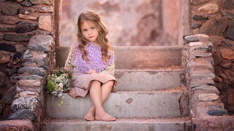 Cute Little Girl Is Sitting On Steps Wearing Purple Peach Color Dress