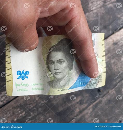 New Thousand Rupiah Banknote in Hand Stock Photo - Image of rupiah