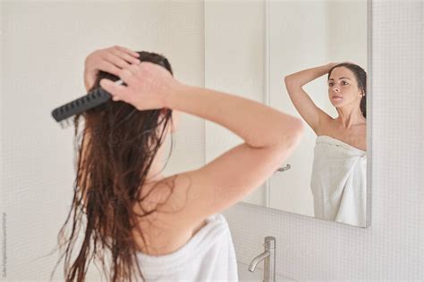 Brunette Brushing Wet Hair In Bathroom By Stocksy Contributor Guille Faingold Stocksy