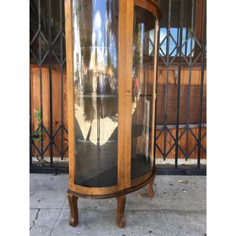 A curio cabinet is a specialised type of display case, made predominantly of glass with a metal or wood framework, for presenting collections of curios, like figurines or other interesting objects that invoke curiosity, and perhaps share a common theme. Antique Traditional Amish Oak Curio Cabinet | Chairish