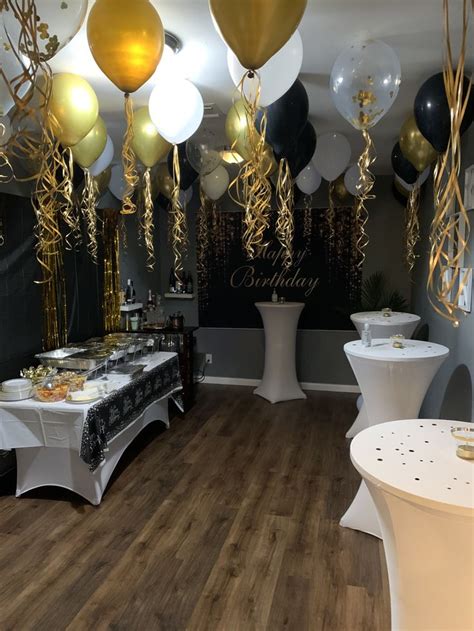 A Party Room With Balloons Tables And Chairs