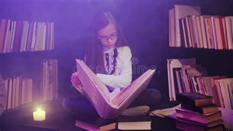 A Girl Opens A Fairy Tale Book In The Library Colored Smoke Swirls