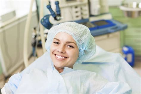 Beautiful Patient Smile Lying On Bed In Surgery Room Hospital