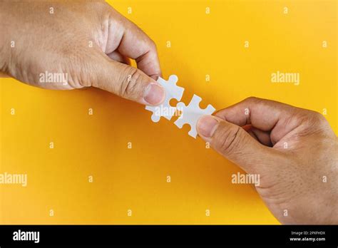 Perfect Match. Two Hands Holding Matching Puzzle Pieces Stock Photo - Alamy