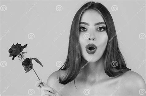 beautiful surprised woman with red rose flower red lips and rose beauty girl sensual mouth