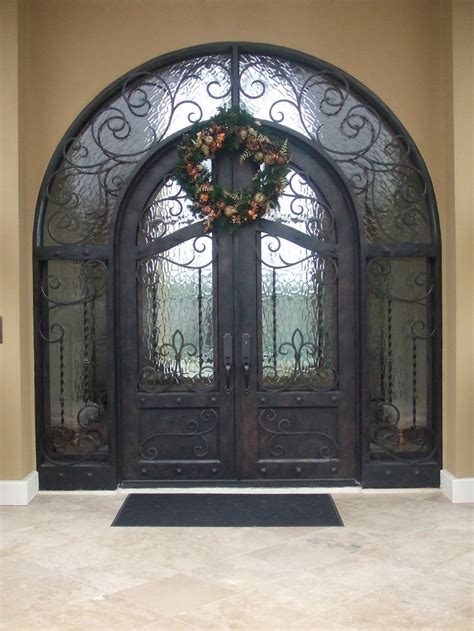An Ornate Iron Door With A Wreath On It