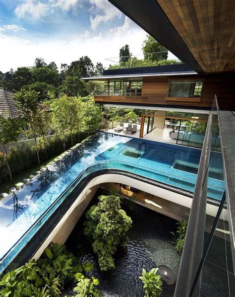 Tropical Home In Singapore With Spiral Staircase Wrapped Around A Glass