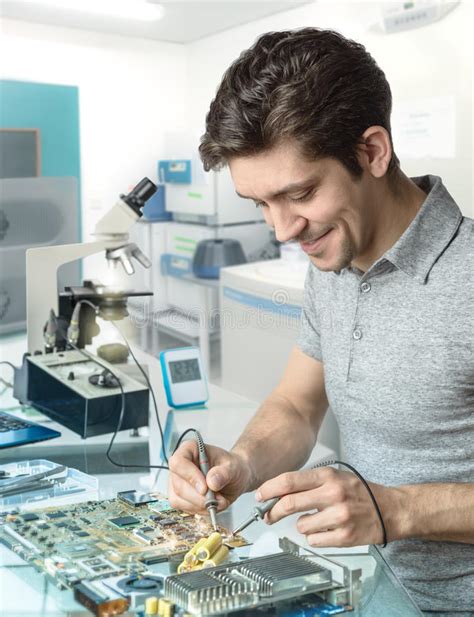 Tech Or Engineer Repairs Electronic Equipment In Research Facility