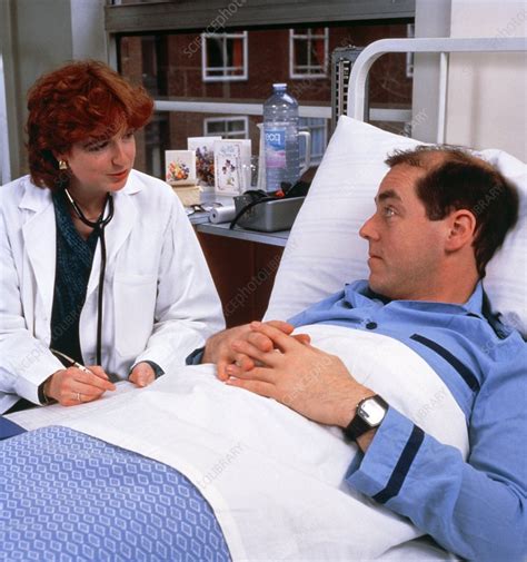 Hospital Doctor Talking To Patient At His Bedside Stock Image M540