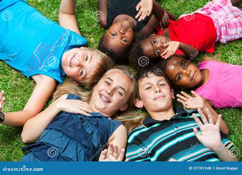 Diverse Group Og Children Laying Together On Grass Stock Photo Image