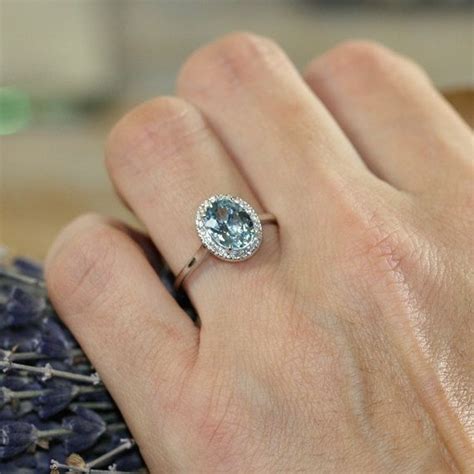 It was bought as a backup ring for the $850 engagement ring i bought her, but she loves it so much she's now wearing them both! Halo Diamond and Aquamarine Engagement Ring in 14k White Gold 9x7mm Oval Aqua Ring (Brida ...