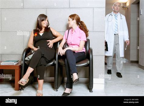 Two Women Sitting In A Hospital Waiting Room Stock Photo Alamy