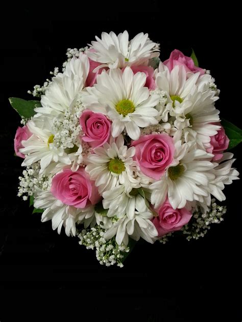 With so many pretty petals to choose from, designing your spring bouquets can be the loveliest challenge! Beautifully simple bouquet...Daisy Chrysanthemums, Roses ...