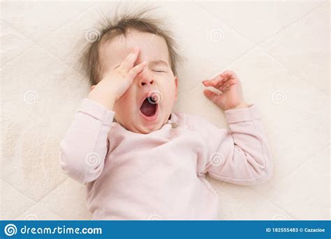 Sleeping Beautiful And Yawning Baby Toddler On The Bed Portrait Stock