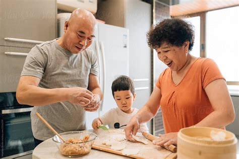 Grandparents Cooking With Grandson By Stocksy Contributor Maahoo