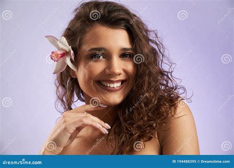 Smiling Female Model With Orchid Behind Ear Stock Image Image Of