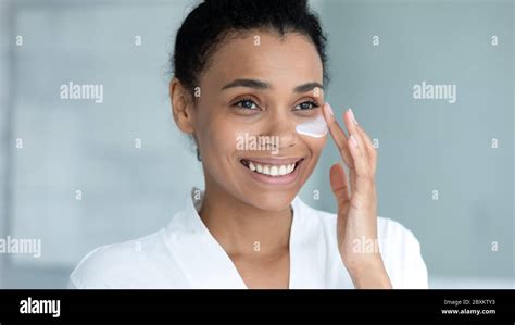 Close Up Smiling African American Woman Applying Moisturizing Cream Stock Photo Alamy