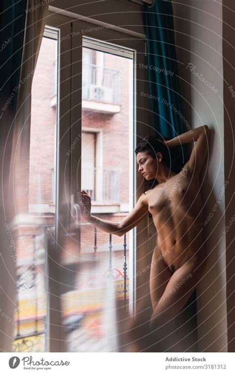 Naked Woman Standing Near Window A Royalty Free Stock Photo From