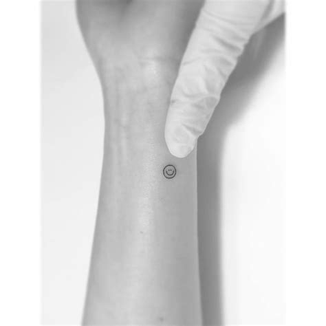 Minimalistic Smiley Tattoo Located On The Wrist