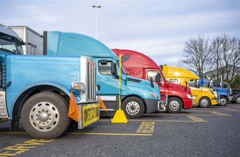 Big Rig Classic Blue Semi Truck With Oversize Load Sign Standing In Row