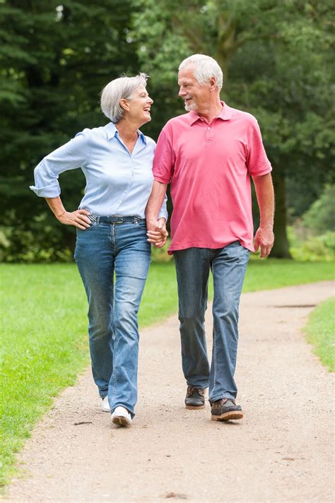 Active And Happy Senior Couple Walking In The Park