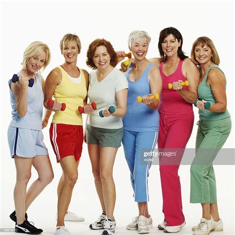 Portrait Of A Group Of Mature Women Holding Dumbbells And Smiling High