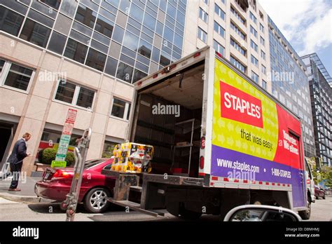 Staples delivery truck parked in front of office building Stock Photo
