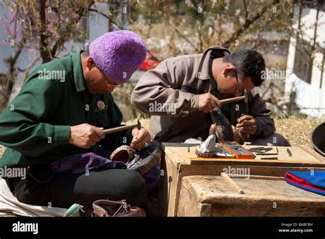 Metal Worker Artist Making Souvenir Trinquets In Thimphu Craft Center