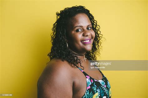 Portrait Of A Plus Size Woman On A Yellow Background High Res Stock