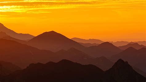 Download Wallpaper 1366x768 Mountains Sunset Fog Dusk Landscape