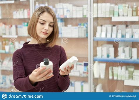 A powder, lotion, lipstick, rouge, or other preparation for beautifying the face, skin, hair, nails, etc · 2. Woman Choosing Cosmetic Products In Pharmacy. Stock Image ...