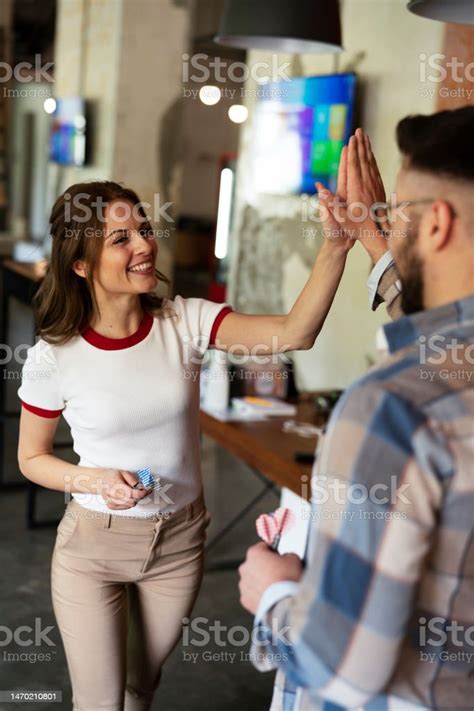 Cheerful Coworkers Giving High Five Stock Photo Download Image Now