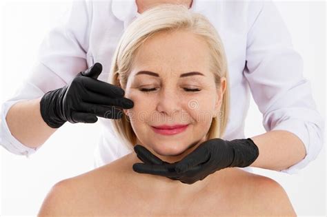Beautician Examines A Woman`s Face With Age Wrinkles Aging And Skin