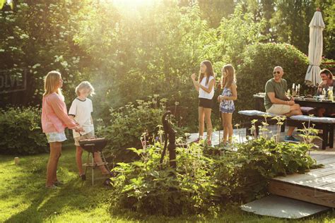 People Enjoying Summer During Garden Party On Sunny Day Stock Photo