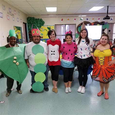 A Group Of People In Costumes Posing For A Photo With One Person