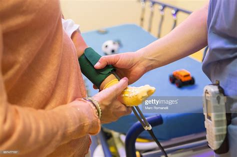 Doctor Measuring Blood Pressure On Leg Of Baby Boy High Res Stock Photo