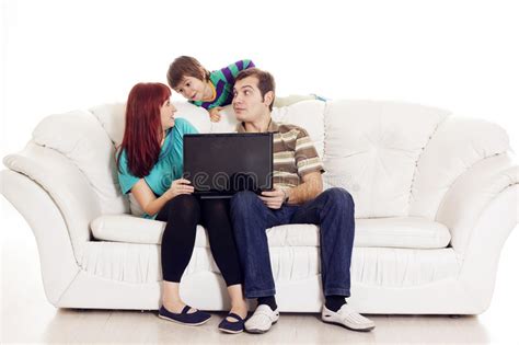 Father Mother And Son Sitting On The Sofa With Notebook Stock Image