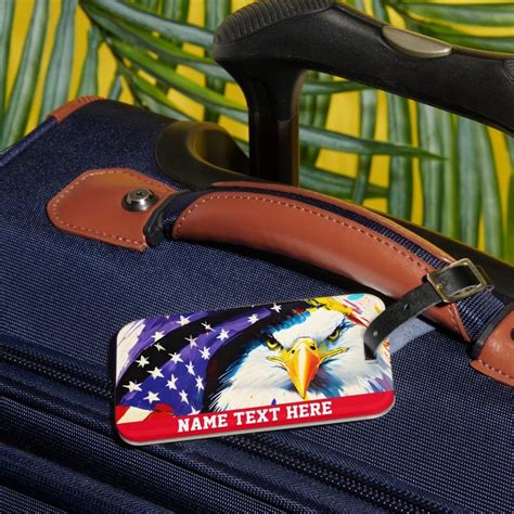 An American Eagle Luggage Tag Is Attached To The Handle Of A Suitcase With Palm Leaves In The