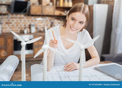 Positive Smiling Engineer Feeling Glad While Doing Her Favorite Work